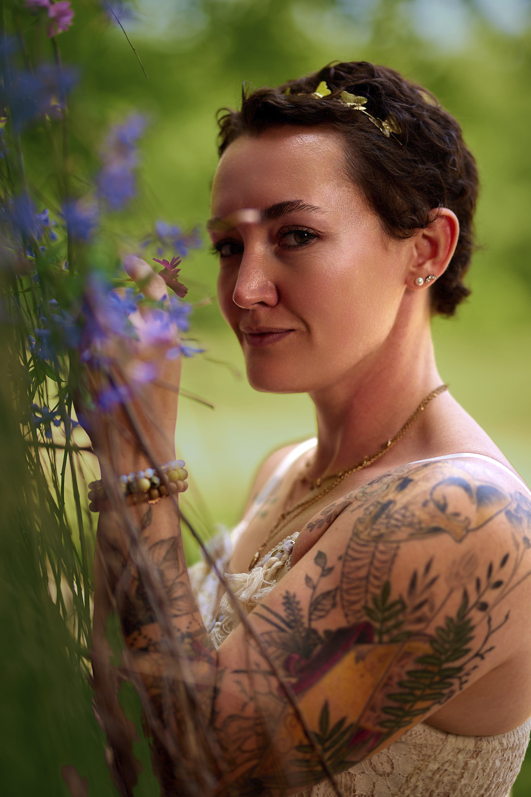 Natural-light portrait of a woman with floral tattoos among wildflowers, Central Illinois portrait photography