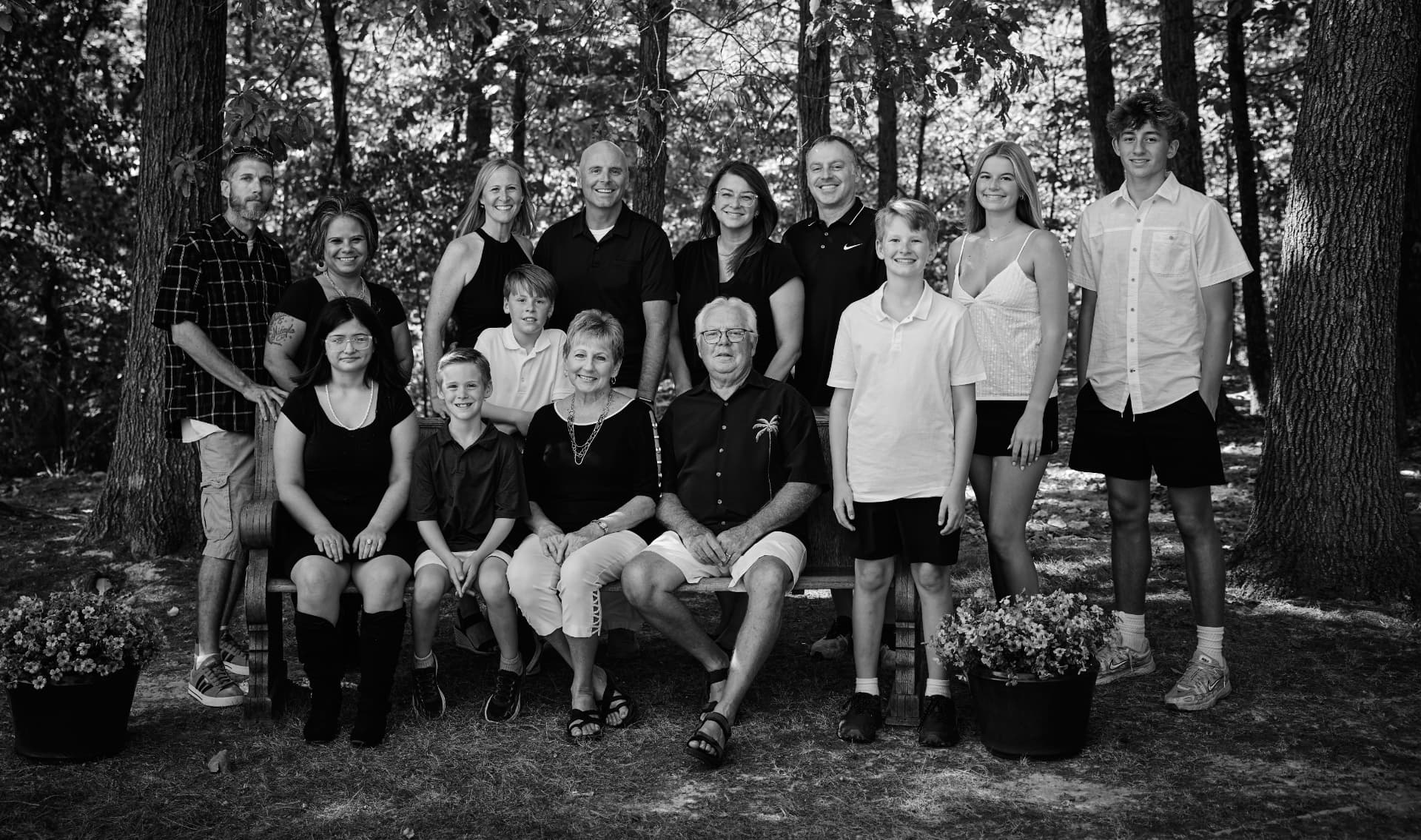 Black and white extended family reunion portrait in the woods by Just Because Photography Studio, Mattoon, IL