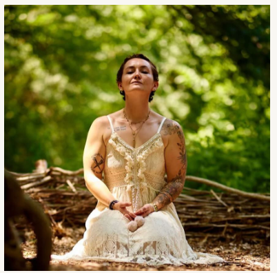 Meditative lifestyle portrait in a sunlit forest near Mattoon, Illinois